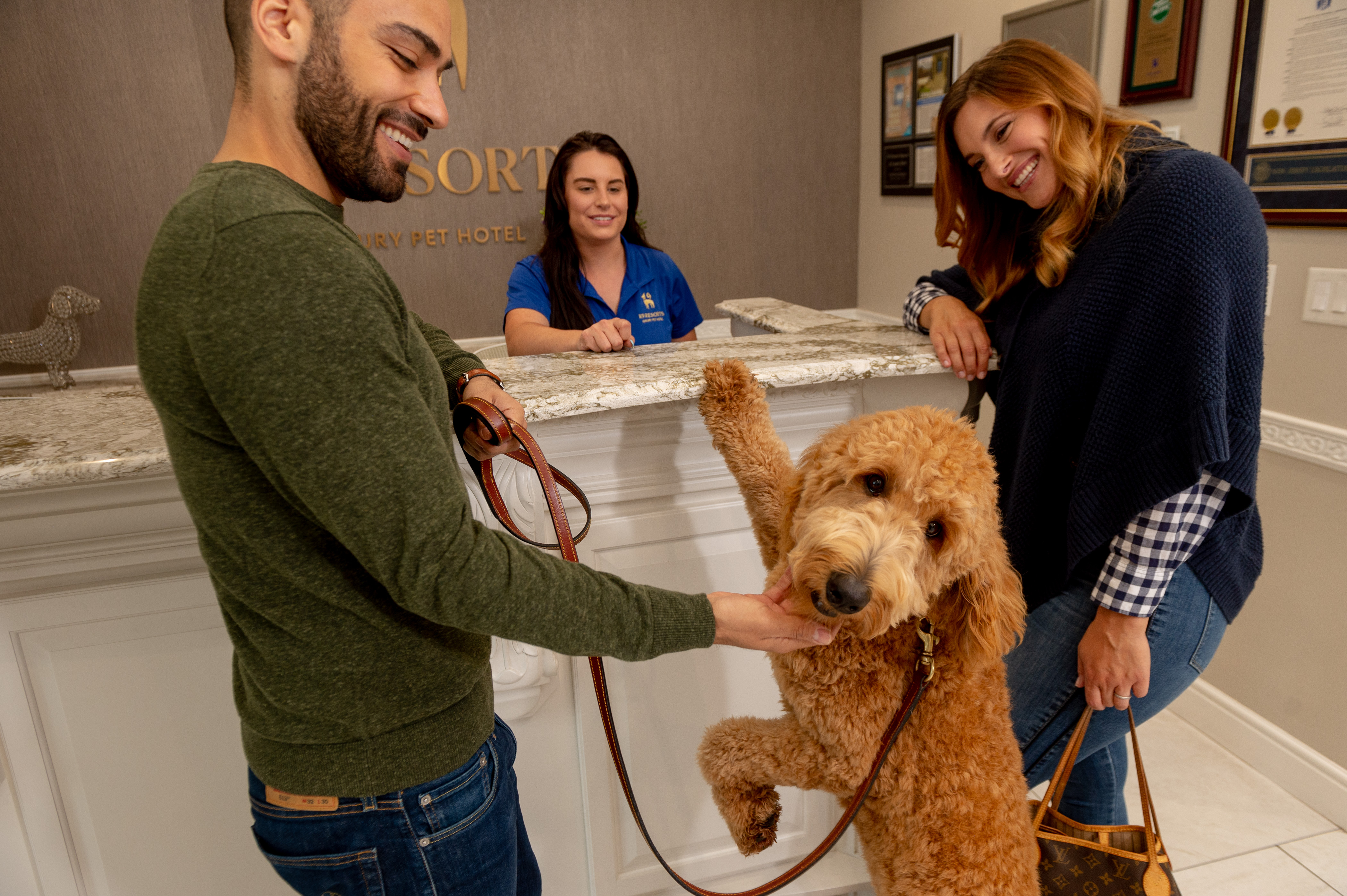 Happy owners checking in their large dog at our doggy daycare.